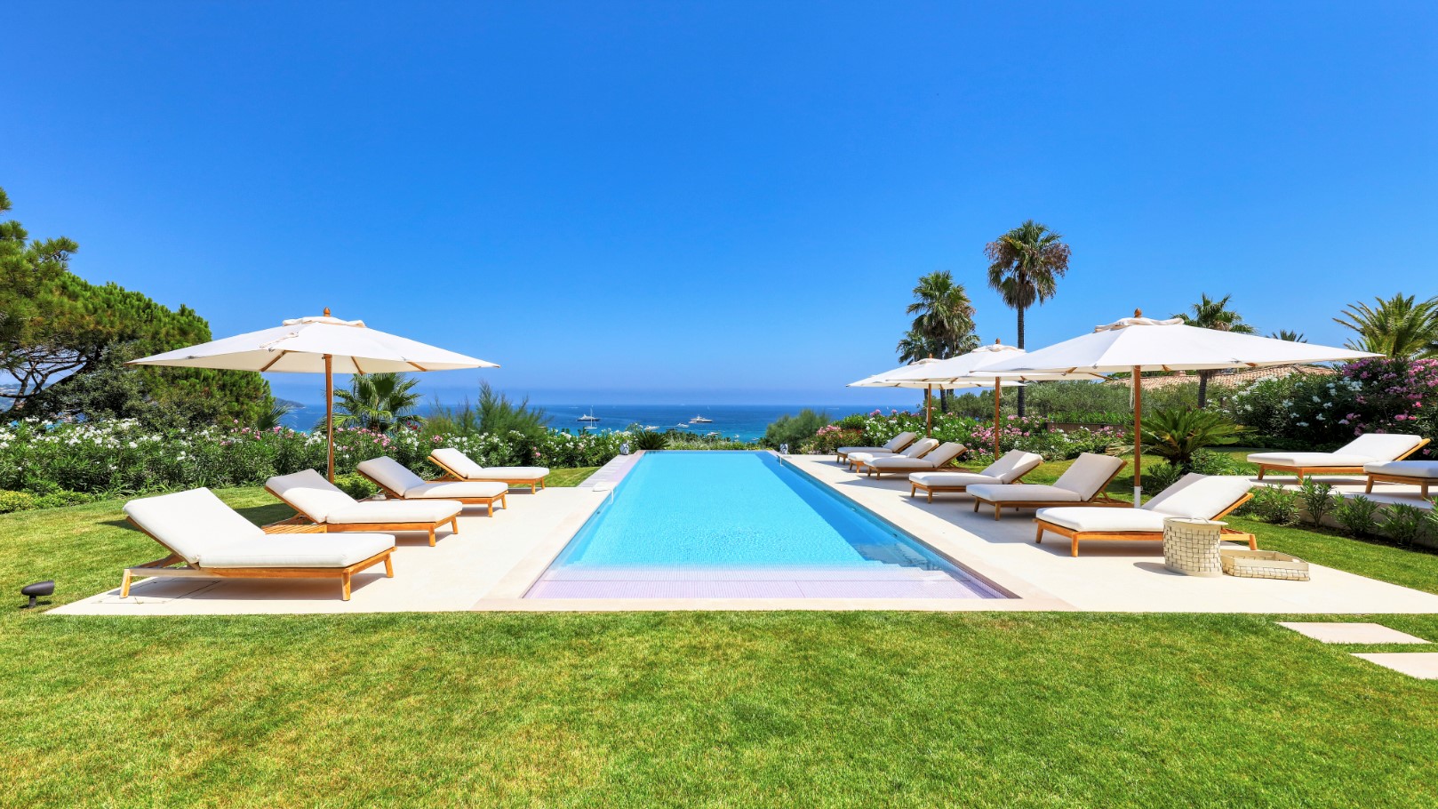 St. Tropez Luxury Villa Rental with infinity pool beautifully overlooking the ocean in the heat of the day